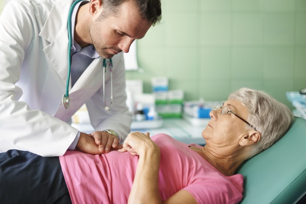 A-doctor-conducts-a-stomach-examination-on-an-elderly-woman-, showcasing-expertise-in-orthopedic-care-in-Kota.jpg