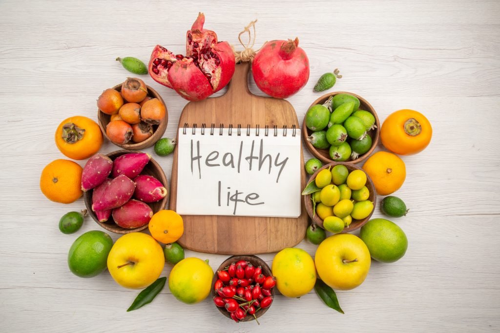 A vibrant assortment of fresh fruits and vegetables arranged on a wooden table - symbolizing a healthy lifestyle.jpg